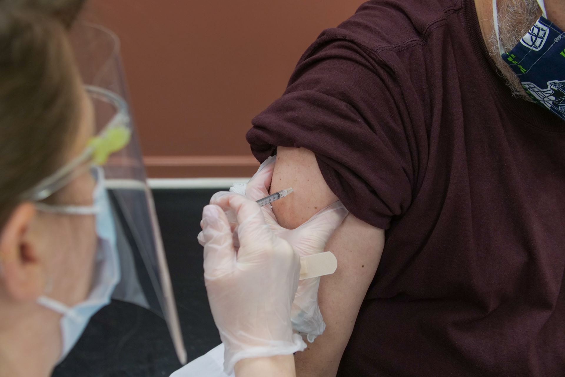 a healthcare professional administering a vaccine