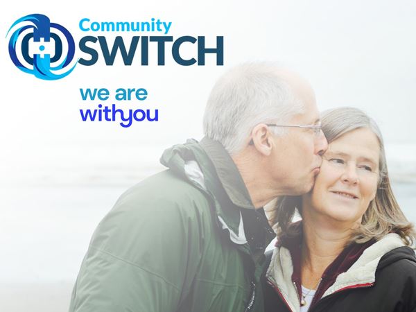 an older man kissing his wife on the cheek, the Community SWITCH logo and the words, we are with you. 